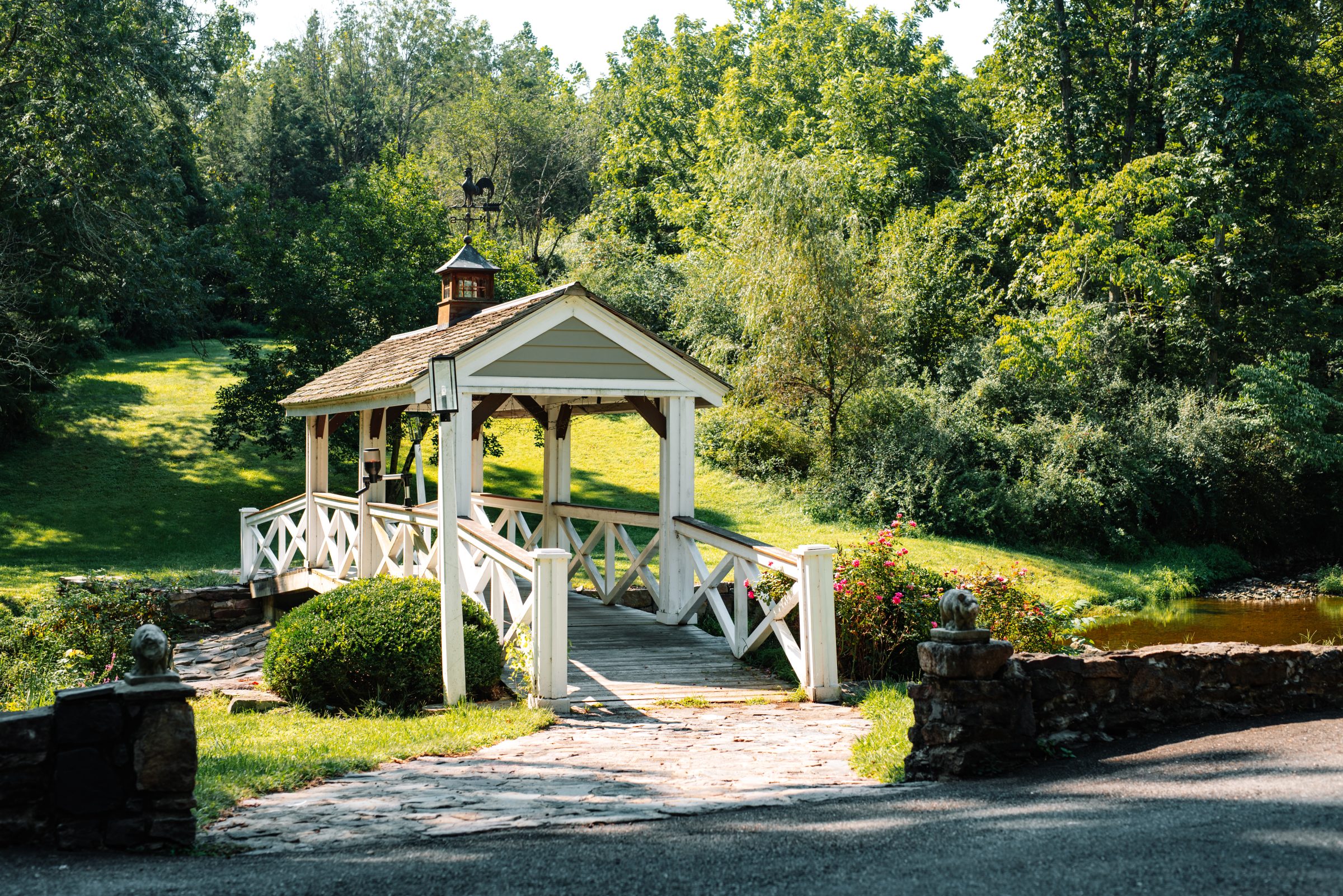 The covered bridge at the stone-pillared drive entrance